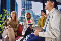 4 persons looking up in the same direction, in a room with glass windows